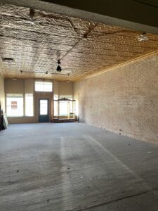 An empty commercial space with brick walls